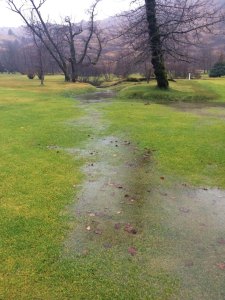 Standing water and stream over the fairway.